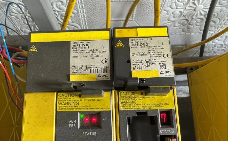 FANUC A06B-6240-H105 and H115 servo amplifiers with status 7 visible on the H115