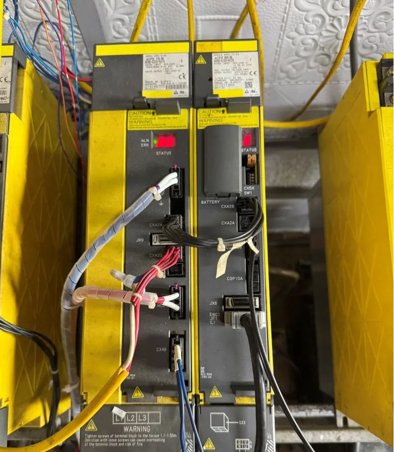 Wiring and connector area around FANUC A06B-6240-H105 and H115 servo amplifiers